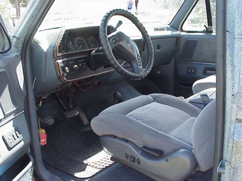 1989 Ford Bronco - View of the driver's side interior of a truck, focusing on the dashboard and seating area.
