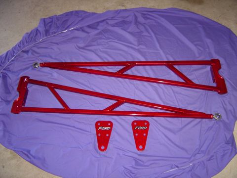 1978 Ford Bronco - Red Ford-branded suspension parts are laid out on a purple cloth.