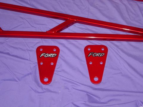 1978 Ford Bronco - Two red Ford plates are attached to a red metal frame, possibly for a vehicle modification.