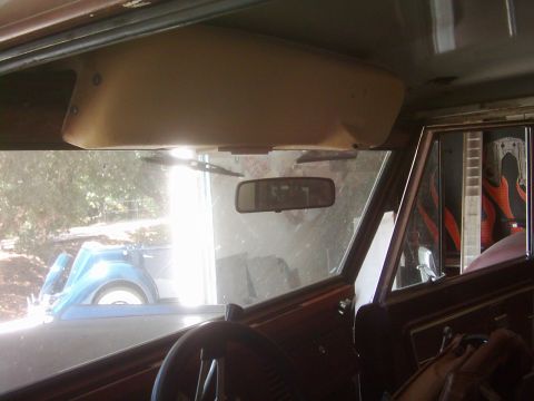 1978 Ford Bronco - View from inside a classic vehicle, looking through the windshield at another car parked outside.
