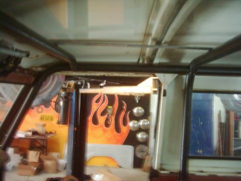 1978 Ford Bronco - Custom flame paint and chrome details are visible inside this vehicle's interior, which also features a roll cage.