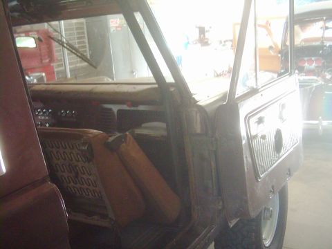 1978 Ford Bronco - The interior of a 1978 Ford Bronco is visible with its doors open, revealing the seats and dashboard area.