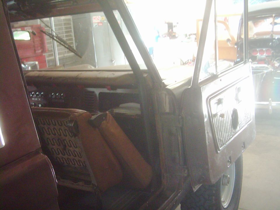 Interior of a 1978 Ford Bronco with open doors, showing seats and dashboard
