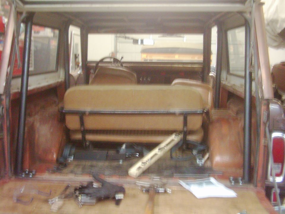 1978 Ford Bronco interior, tan seats, roll cage, cargo area with tools and parts