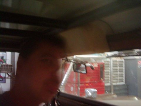 1978 Ford Bronco - Interior view from driver's seat, looking through windshield at exterior scene.
