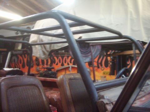 1978 Ford Bronco - Custom roll cage installed inside a vehicle with flame graphics on the interior panels.