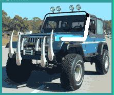 1979 Ford Bronco - A modified blue Jeep Wrangler is parked outdoors, aggressive off-road modifications and a distinctive bull bar.