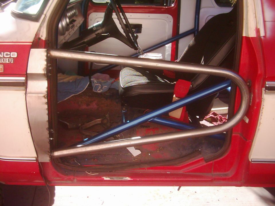 Interior of a 1978 Ford Bronco with tube doors and roll cage