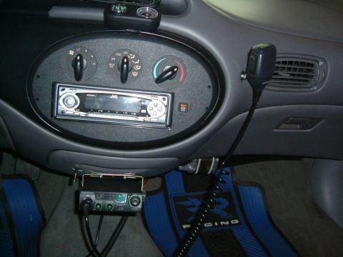 1996 Ford Taurus - The interior of a 1996 Ford Taurus shows an aftermarket stereo and a CB radio mounted below the dash.