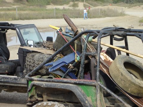 1992 Ford Bronco - This heavily modified off-road vehicle is packed with various items, including tools and spare tires, suggesting it's prepared for use.