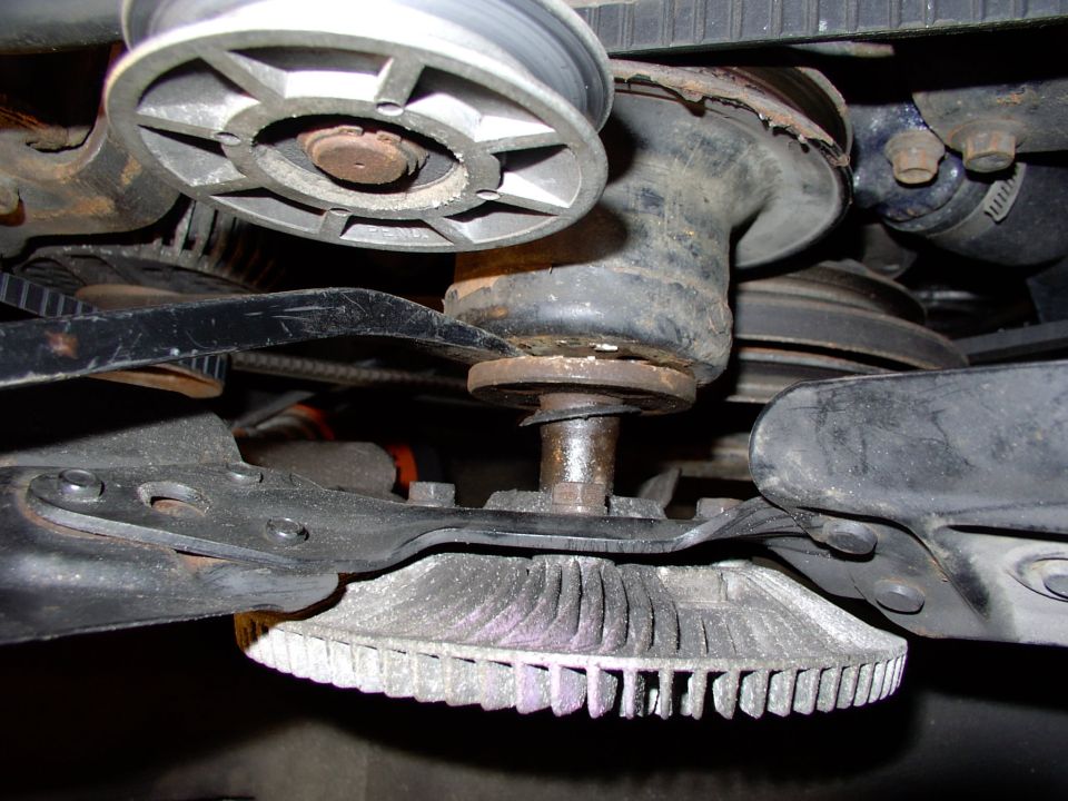 Lever off the fan assembly as a unit and be careful not to let it fall and damage the radiator.