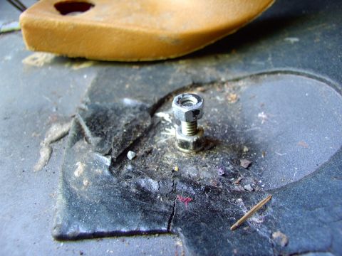 1986 Ford Bronco - Using one of the center console's rear mounting holes, as a locator, I stick this 1/4" bolt up from under the truck and secure it with a nu…