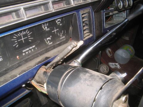 1981 Ford Bronco - Interior view of a vehicle's dashboard, showing gauges and steering column with exposed wiring.