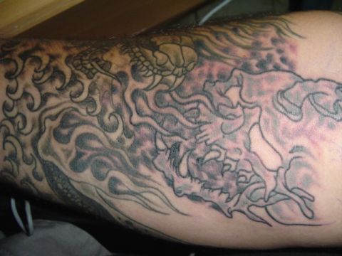 1993 Ford Bronco - A detailed tattoo depicts a dragon amidst swirling waves, with a turtle visible near the top.
