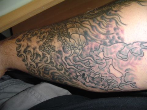 1993 Ford Bronco - Dragon tattoo artwork covers a person's arm.