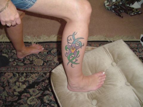 1993 Ford Bronco - A leg displays a tribal flower tattoo, with another person's feet visible in the background.