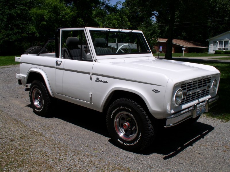 White 1967 Ford Bronco convertible parked on a gravel driveway