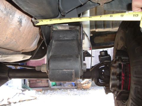 1989 Ford Bronco - Close-up of a vehicle's suspension component being measured.