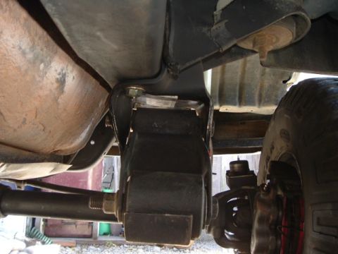 1989 Ford Bronco - Close-up of the vehicle's undercarriage, focusing on suspension parts and a tire.