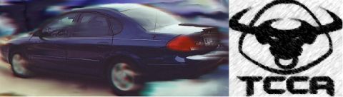 2000 Ford Taurus - A dark blue 2000 Ford Taurus is seen from the rear with motion blur, next to a TCCA logo.