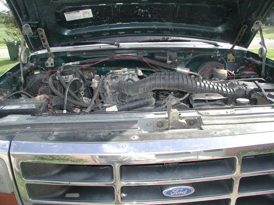 Green 1993 Ford Bronco engine bay with chrome grille visible