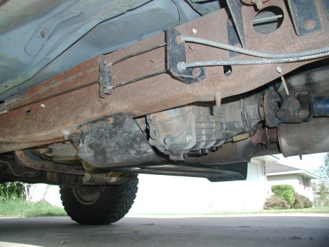 1993 Ford Bronco - Undercarriage view showing drivetrain components and a tire. Year is not discernible.