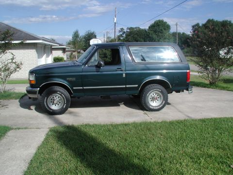 1993 Ford Bronco - This Ford Bronco is parked in front of a house on a sunny day.