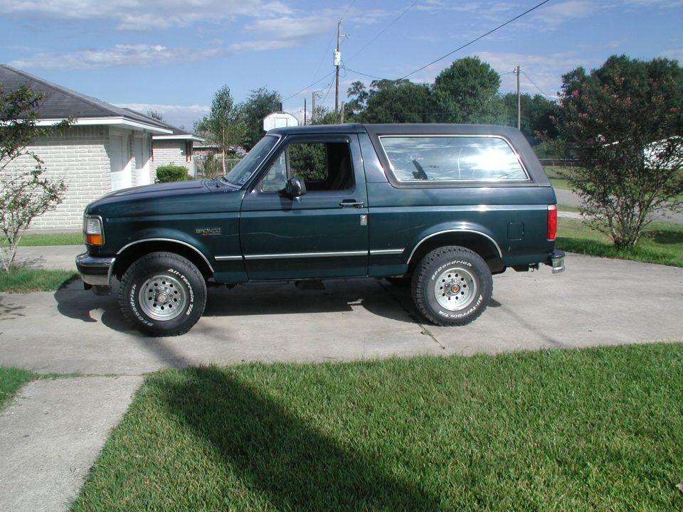 Green Ford Bronco parked on a driveway
