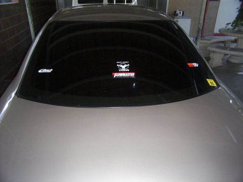 1998 Mercury Sable - Car's rear window displays various aftermarket performance stickers, including Flowmaster and K&N.