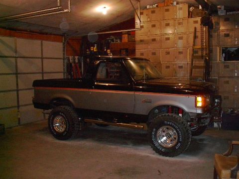 1989 Ford Bronco - This 1989 Ford Bronco is parked inside a garage with storage shelves in the background.
