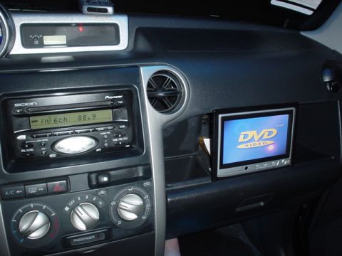 1993 Ford Taurus - The interior of a car features a Pioneer stereo and an installed DVD video screen.