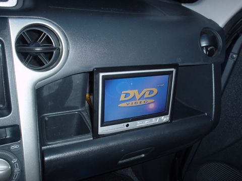 1993 Ford Taurus - The interior of a car shows a dashboard with an aftermarket DVD player installed.