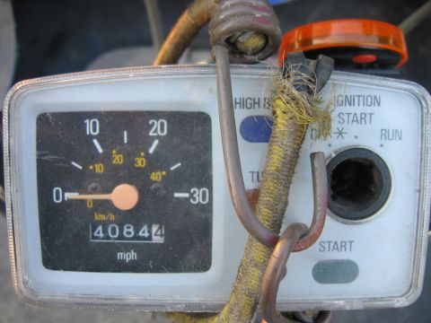 1985 Ford LTD Crown Victoria - Close-up of a motorcycle's instrument panel, showing the speedometer and odometer.