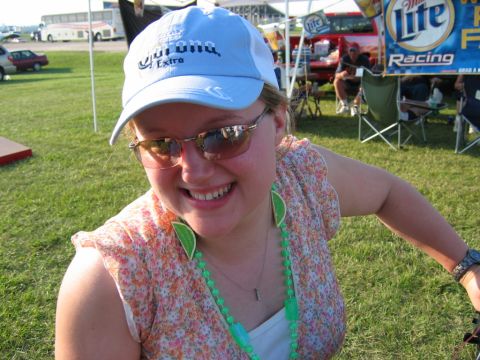 1985 Ford LTD Crown Victoria - Woman wearing a Corona Extra hat and sunglasses at an outdoor event.