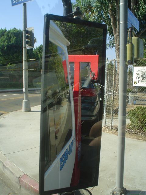 1993 Ford Taurus - Reflection in a side mirror shows a red truck with white lettering and a dark car.