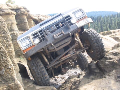 1995 Ford Bronco - This modified Ford Bronco navigates a challenging rocky obstacle course, its off-road capabilities.
