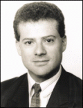 1994 Ford Crown Victoria - A black and white headshot of a man wearing a suit and tie.