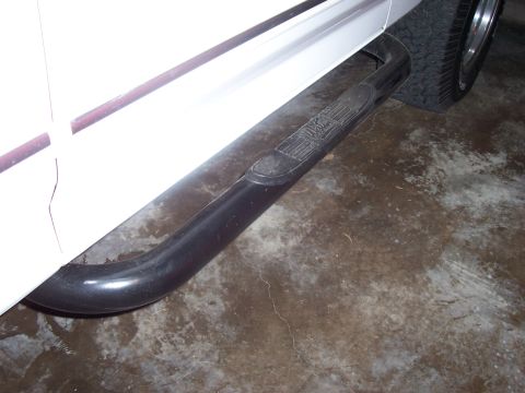1994 Ford Bronco - Running board step on the side of a white vehicle.