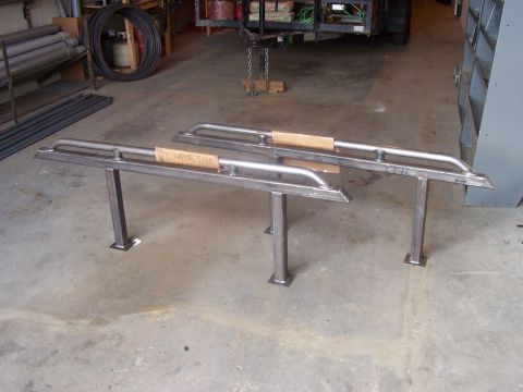 1994 Ford Bronco - Custom metal sliders are shown standing upright in a workshop setting.