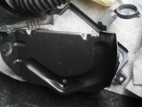1993 Ford Taurus - Close-up of a black painted engine bay component with a bracket.