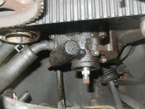 1993 Ford Taurus - Close-up view of an engine component with visible oil leaks and a timing belt.