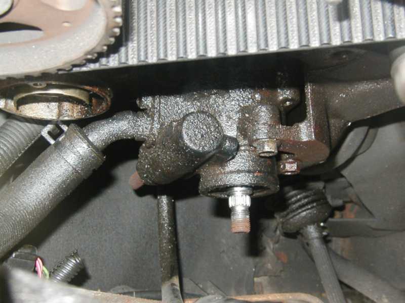 Engine part with oil leaks, timing belt, and pulley