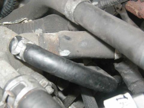 1993 Ford Taurus - This image shows a close-up view of various engine hoses and their connections, typical of a vehicle's internal mechanics.