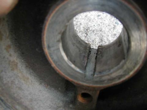 1993 Ford Taurus - Interior view of a damaged metal pipe, showing debris and wear.