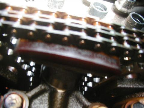 1993 Ford Taurus - A close-up view of the timing chain and tensioner mechanism within a vehicle's engine.