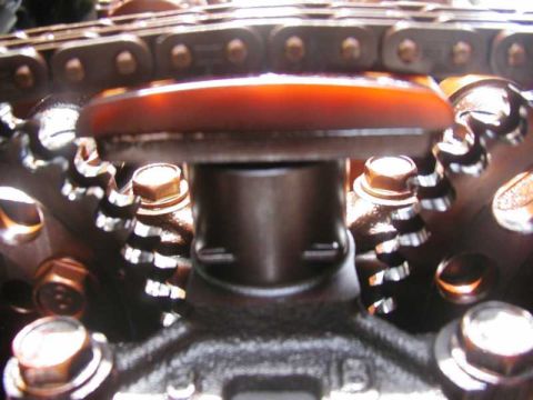 1993 Ford Taurus - Close-up view of engine timing components, including a chain, sprockets, and tensioner.