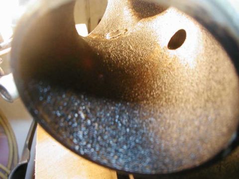 1993 Ford Taurus - Close-up view of the inside of an exhaust pipe, showing significant carbon deposits and wear.