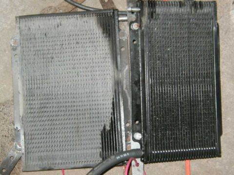 1993 Ford Taurus - Transmission cooler with visible hoses and mounting brackets. The fins appear to be dirty and possibly damaged.