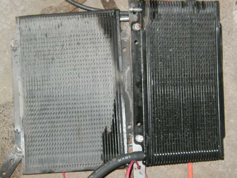 transmission cooler with two distinct fin sections, one gray and one black, with hoses attached