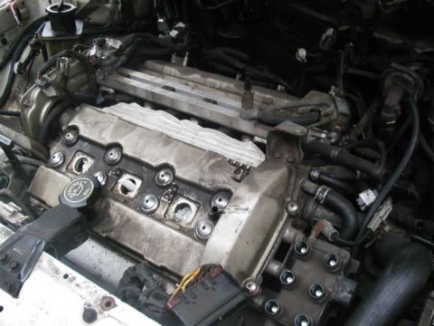 1993 Ford Taurus - The engine bay is shown with the valve covers removed, revealing internal components and wiring.